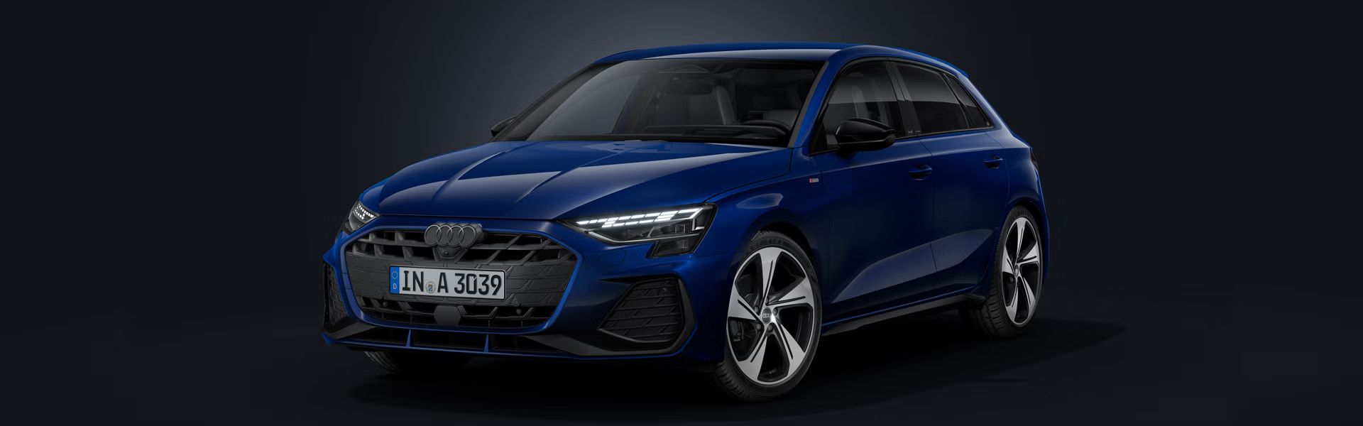 Der Audi A3 Sportback schräg von vorne auf dunklem Hintergrund.