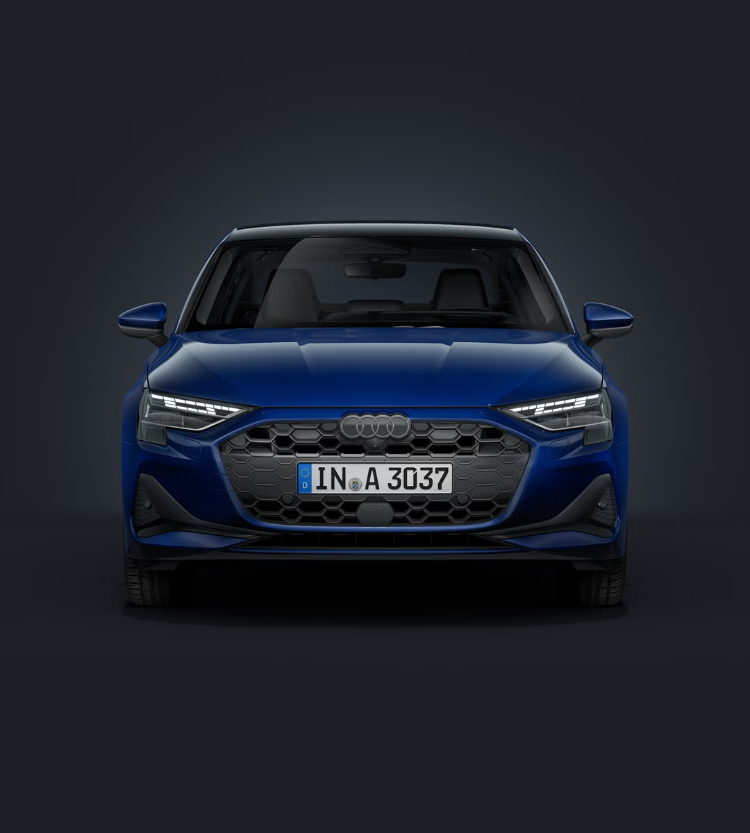 Die Audi A3 Limousine frontal von vorn auf dunklem Hintergrund.